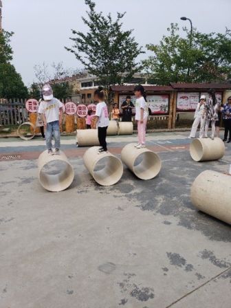 Children playing on makeshift toys