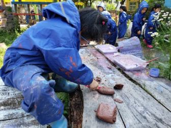Children breaking clay and other items