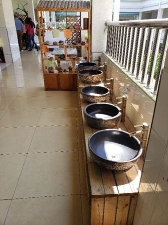 Bowls lined up on a balcony under the sun