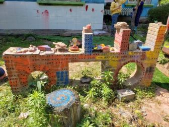 A sculpture made of painted bricks