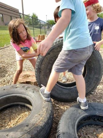 Four children move tires