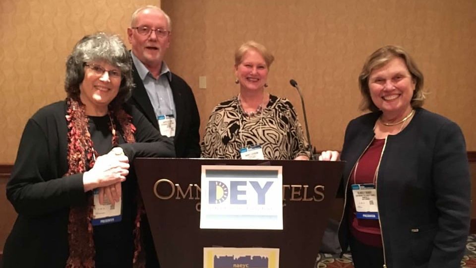 Blakely Bundy, Dr. Diane Levin, Dr. Marcy Guddemi, and James St. Clair stand next to a podium