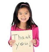 Young girl holding a sign that says thank you.
