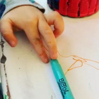 Child holding pen child holding pen