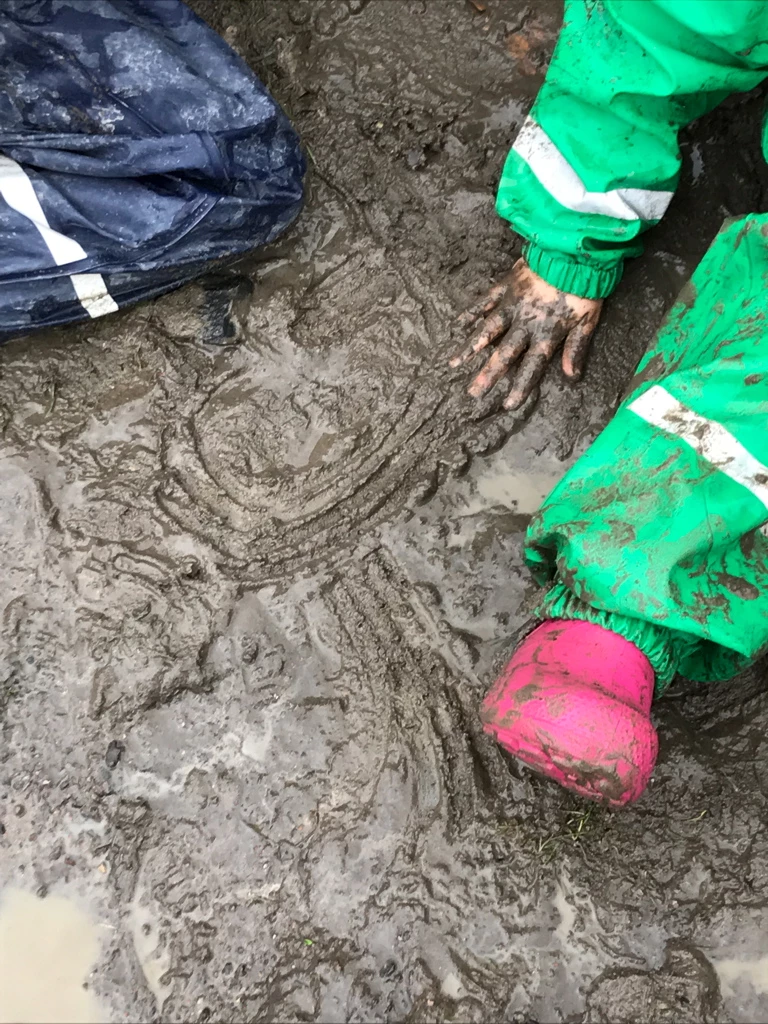 mud child drawing with mud